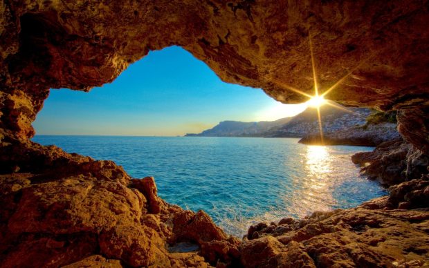 Sea beach rock cave sun sunset.