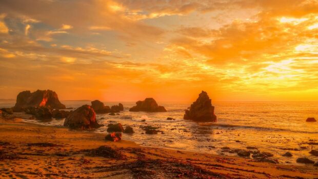 Wonderful rocky beach under yellow sunset hd wallpaper 1920x1080.