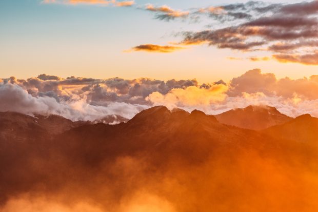 Cool Landscape photography of mountains with cloudy skies during golden hour.