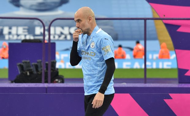 Pep Guardiola kissed his medal after winning his third Premier League.