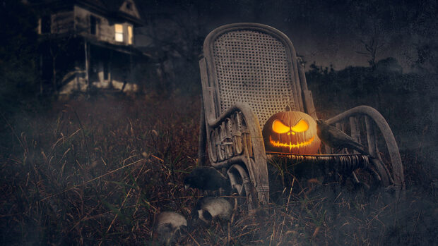 Spooky Halloween scene with glowing jack-o'-lantern, skulls, raven, old wicker chair, and haunted house in background during dark night.