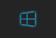 Windows logo 11 illuminated with a blue glow on a dark background.