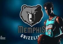 Memphis Grizzlies player in jersey holding basketball with team logo background and name.
