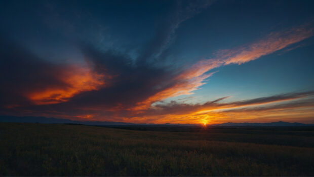 Majestic summer sky wallpaper with a gradient of deep blue transitioning to fiery orange.