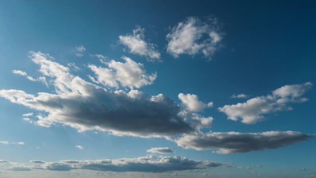 Minimalist summer sky wallpaper with a gradient of blue and a single wispy cloud.